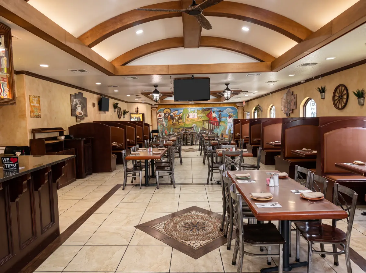 El comedor principal de Jimador bajo vigas arqueadas, con el mural pintado a mano de Jalisco al fondo